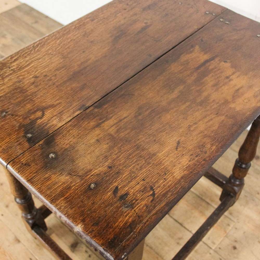 An 18th-century oak side table featuring a rectangular top, a single frieze drawer, four baluster-turned legs, and low box stretchers. View IX