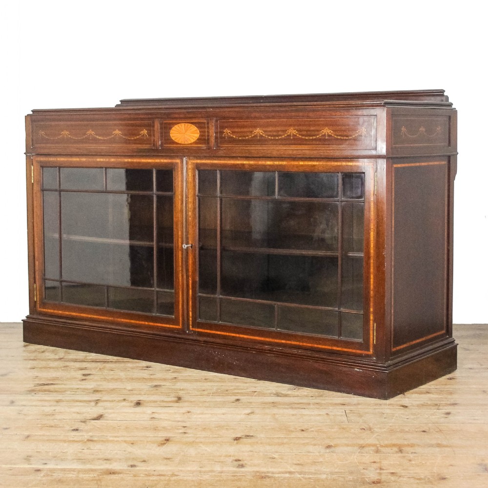 An Edwardian mahogany low side cabinet featuring twin glazed doors with astragal moulding and satinwood husk inlay. View III