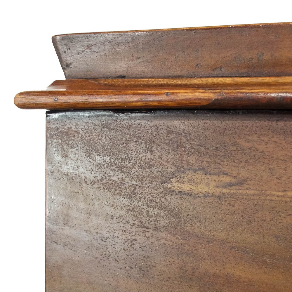 A Victorian mahogany Davenport desk featuring a sloped writing surface, turned support columns, and four stacked drawers on the right side. View V