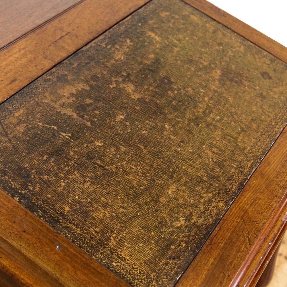 A Victorian mahogany Davenport desk featuring a sloped writing surface, turned support columns, and four stacked drawers on the right side. View VII