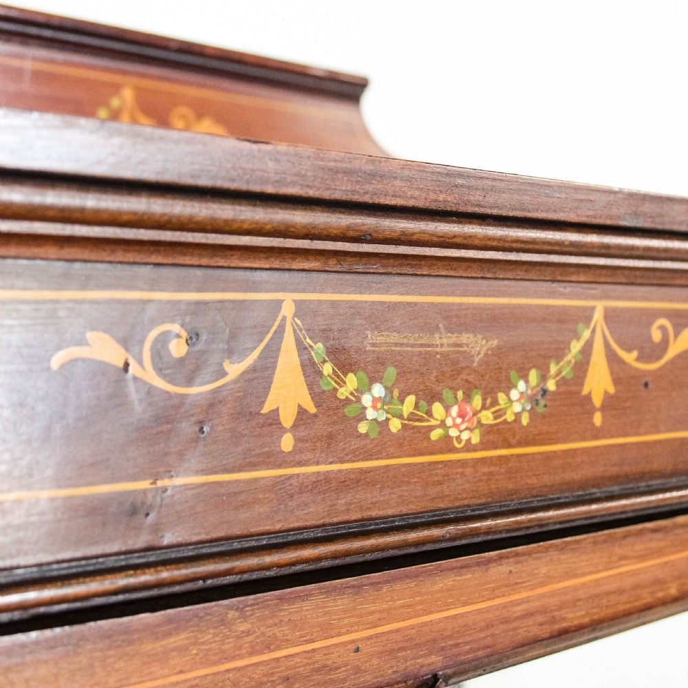 An Edwardian mahogany display cabinet featuring a painted floral frieze, a single glazed door with diamond astragal bars, and tall square tapered legs. View VIII