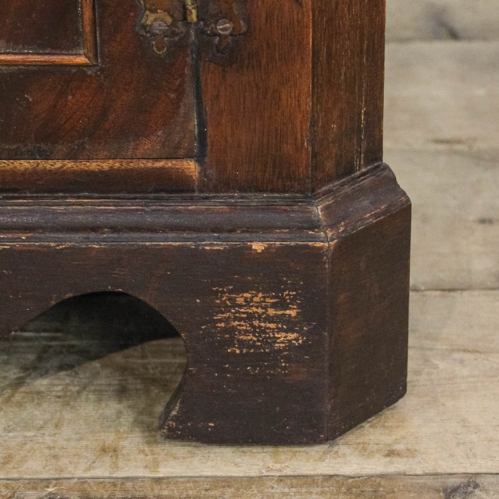 A pair of tall mahogany corner cabinets with arched tops, blue-painted shelf interiors, and floral inlaid panels on the lower door. View VII