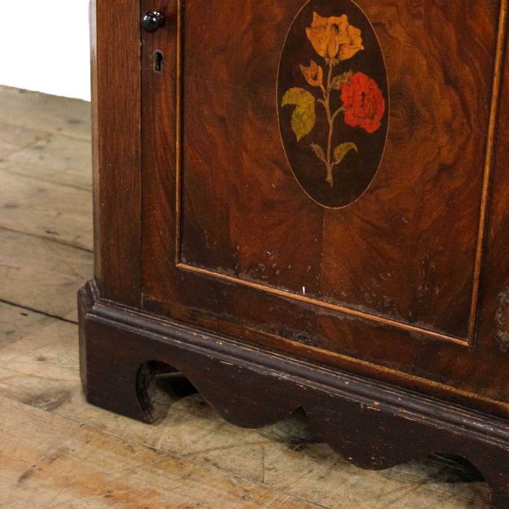 A pair of tall mahogany corner cabinets with arched tops, blue-painted shelf interiors, and floral inlaid panels on the lower door. View VIII