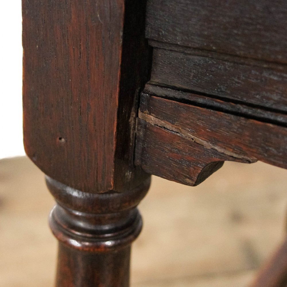 A square dark oak joint stool featuring turned legs, peg joinery, and a low perimeter box stretcher. View II