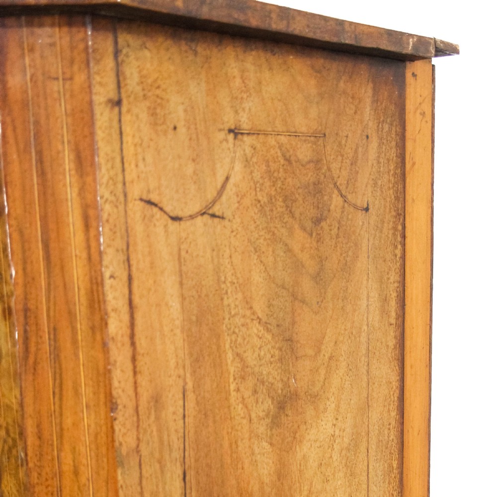 An antique Edwardian walnut music cabinet featuring a glazed door with vertical internal dividers and brass castors. View VIII