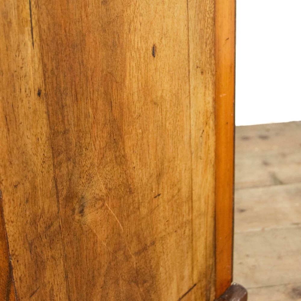 An antique Edwardian walnut music cabinet featuring a glazed door with vertical internal dividers and brass castors. View IX
