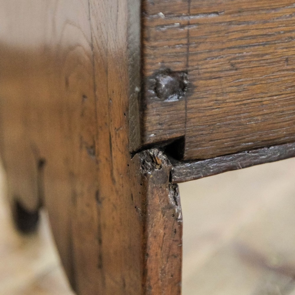 An 18th-century solid oak sword chest featuring a rectangular lift-top lid, iron lockplate, and cutout side supports. View XIII