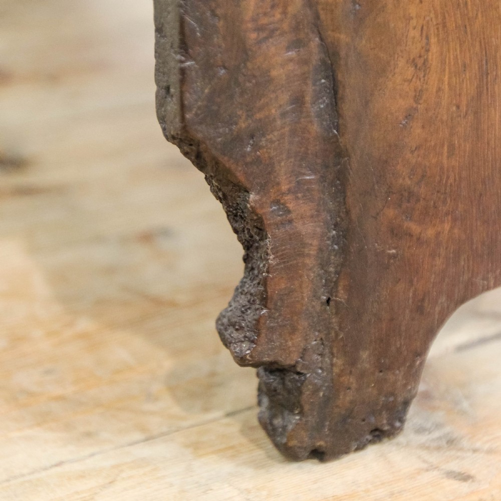 An 18th-century solid oak sword chest featuring a rectangular lift-top lid, iron lockplate, and cutout side supports. View XIV