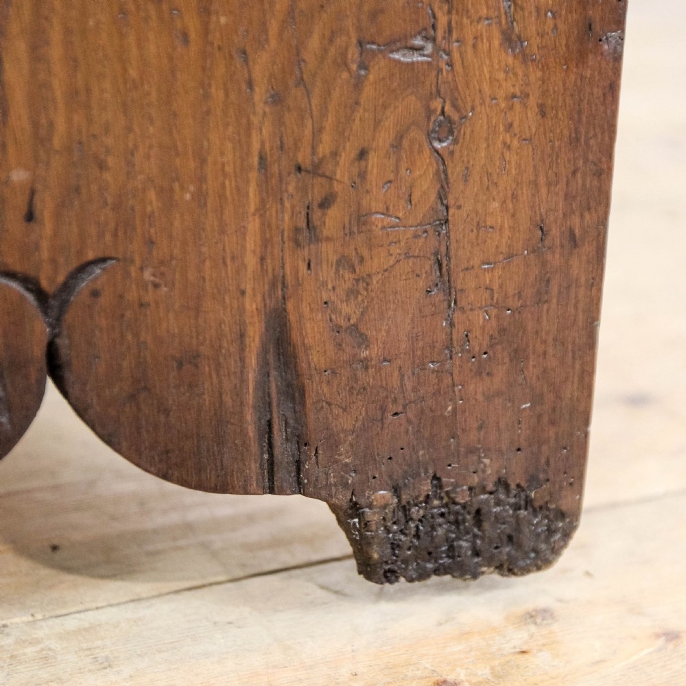 An 18th-century solid oak sword chest featuring a rectangular lift-top lid, iron lockplate, and cutout side supports. View XV