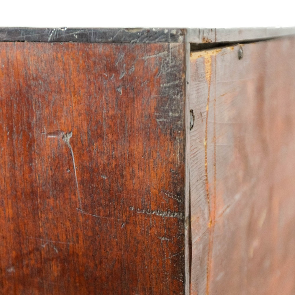 An antique mahogany writing bureau with a slant-front fall, four graduated drawers, oval brass handles, and bracket feet. View IX