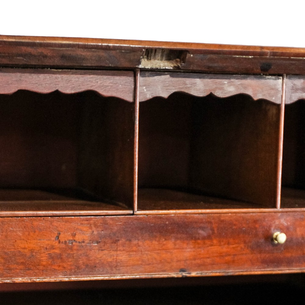 An antique mahogany writing bureau with a slant-front fall, four graduated drawers, oval brass handles, and bracket feet. View XIV