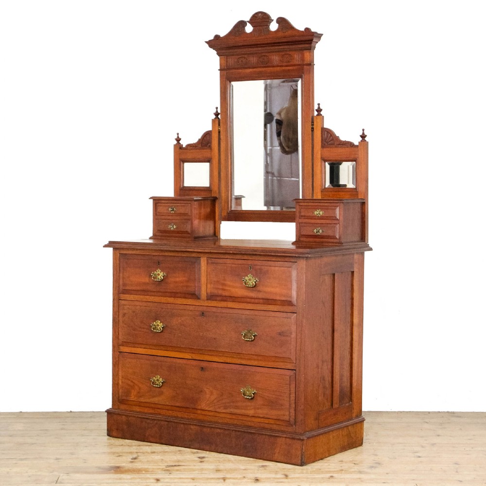 A Victorian carved oak dressing chest featuring an upper mirror superstructure with small side drawers and a lower three-tier chest of drawers on a plinth base. View II