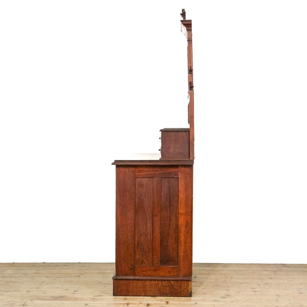 A Victorian carved oak dressing chest featuring an upper mirror superstructure with small side drawers and a lower three-tier chest of drawers on a plinth base. View IV