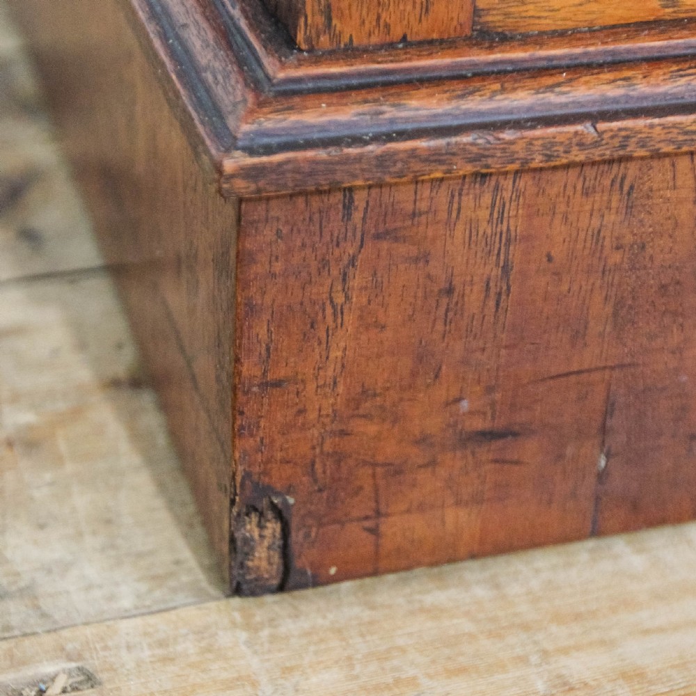 A Victorian carved oak dressing chest featuring an upper mirror superstructure with small side drawers and a lower three-tier chest of drawers on a plinth base. View X