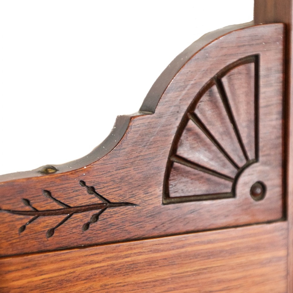 A Victorian carved oak dressing chest featuring an upper mirror superstructure with small side drawers and a lower three-tier chest of drawers on a plinth base. View XII