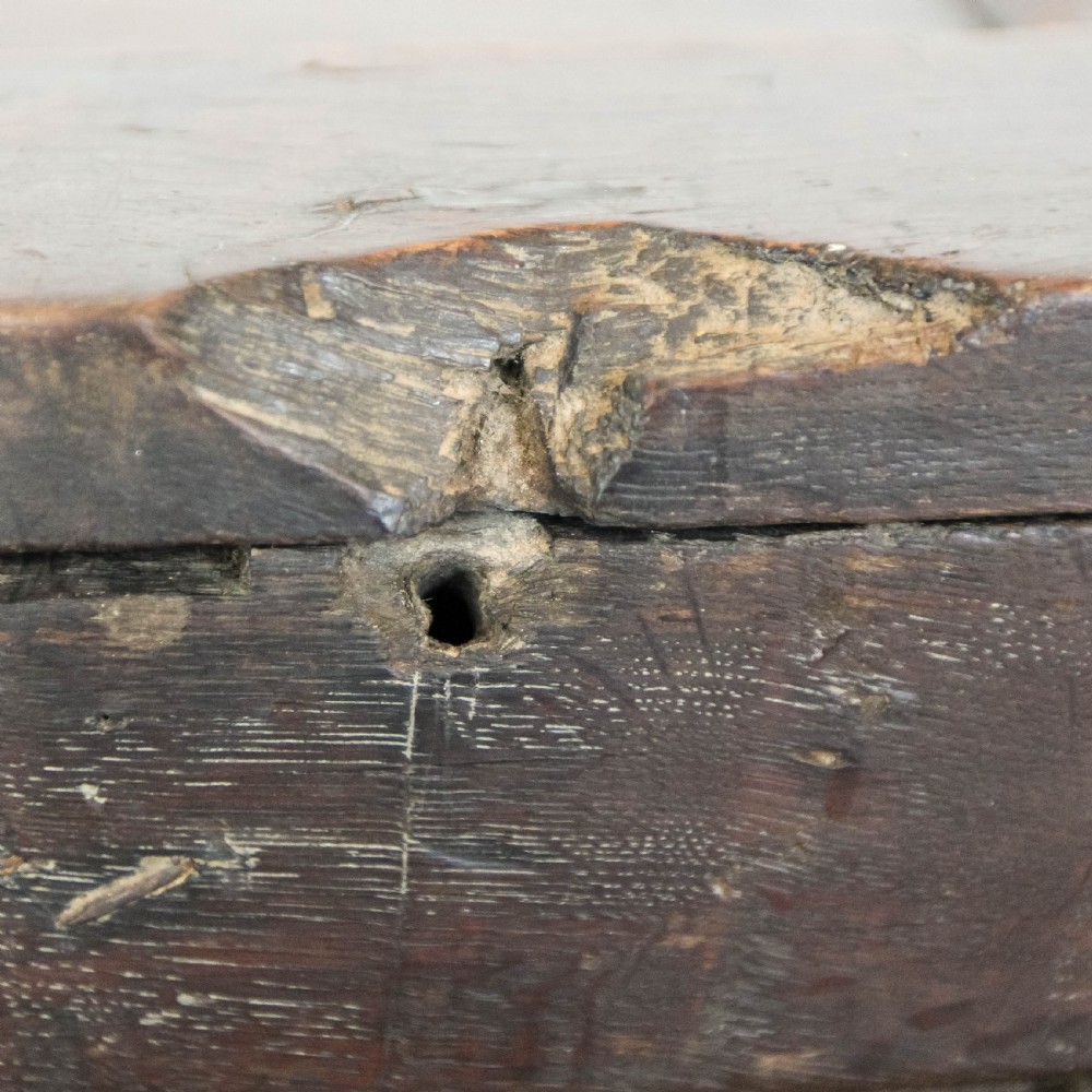 A 19th-century dark oak coffer featuring carved floral scroll panels, a decorative frieze, and sturdy block feet. View VIII