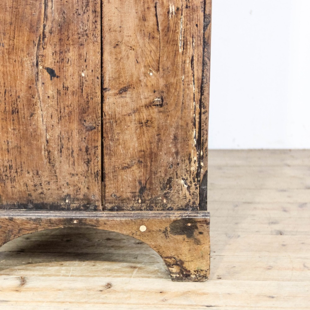 A nineteenth-century two-part oak housekeepers cupboard featuring twin panelled upper doors above two short and three long drawers with brass hardware. View IV