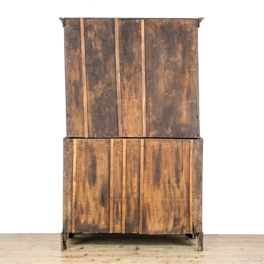 A nineteenth-century two-part oak housekeepers cupboard featuring twin panelled upper doors above two short and three long drawers with brass hardware. View VIII
