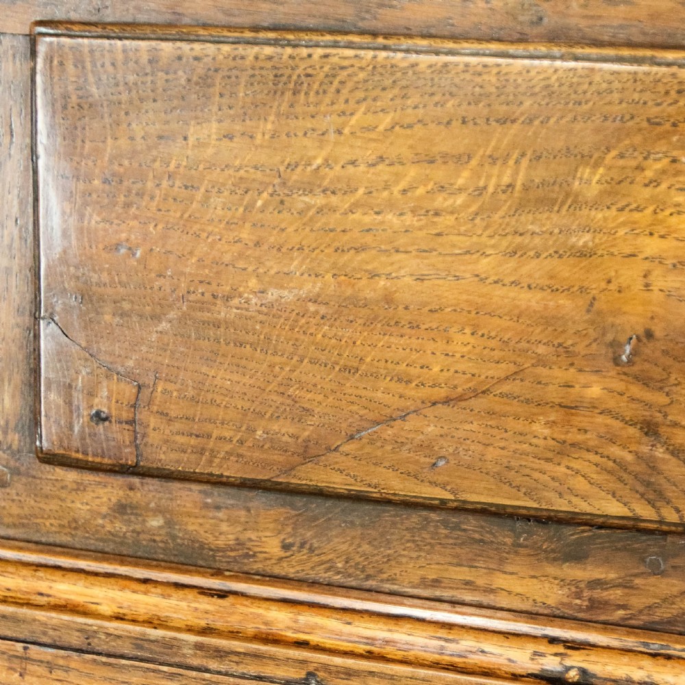 A nineteenth-century two-part oak housekeepers cupboard featuring twin panelled upper doors above two short and three long drawers with brass hardware. View XVI