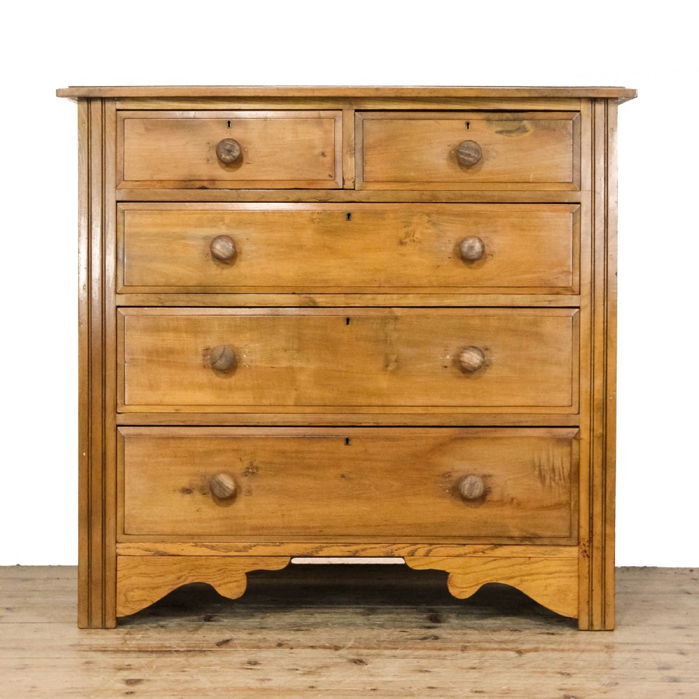 An antique satinwood chest of drawers with two short drawers over three long graduated drawers fitted with turned wooden handles.