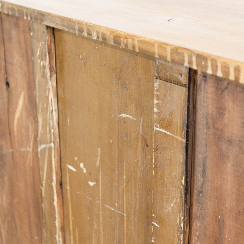 An antique satinwood chest of drawers with two short drawers over three long graduated drawers fitted with turned wooden handles. View VII
