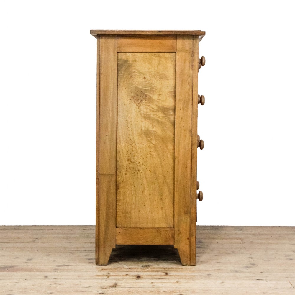 An antique satinwood chest of drawers with two short drawers over three long graduated drawers fitted with turned wooden handles. View VIII