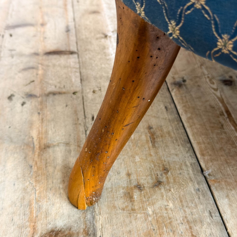 A Victorian carved walnut settee with double button-tufted balloon backrests and blue patterned fabric upholstery. View XIII