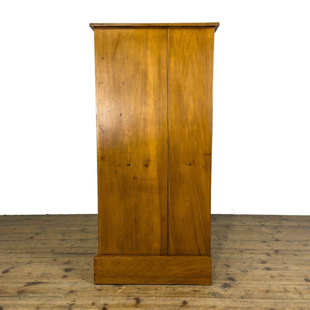 An Edwardian satinwood chest of drawers with two short drawers over three long drawers, featuring brass drop handles and a plinth base. View III