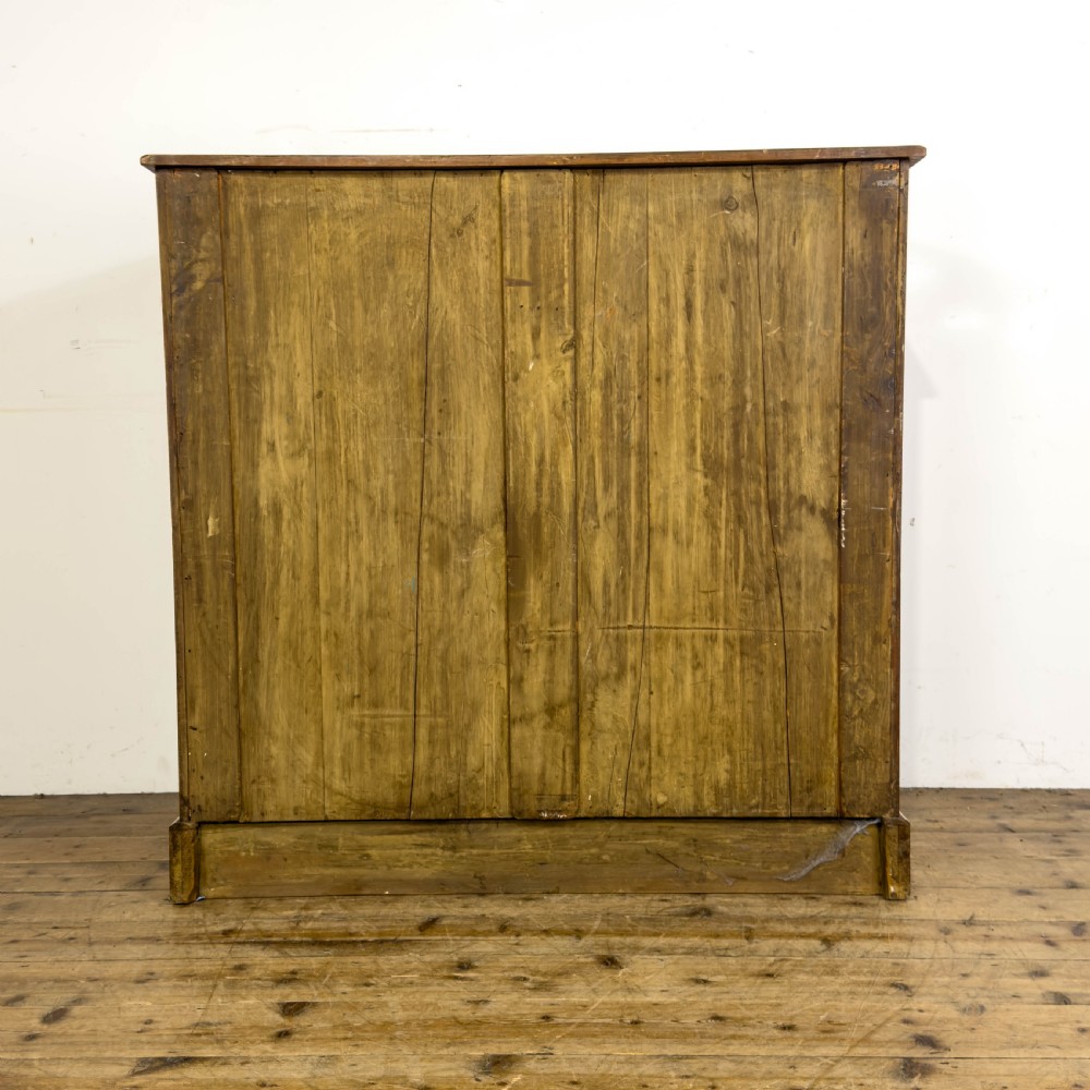 An Edwardian satinwood chest of drawers with two short drawers over three long drawers, featuring brass drop handles and a plinth base. View V