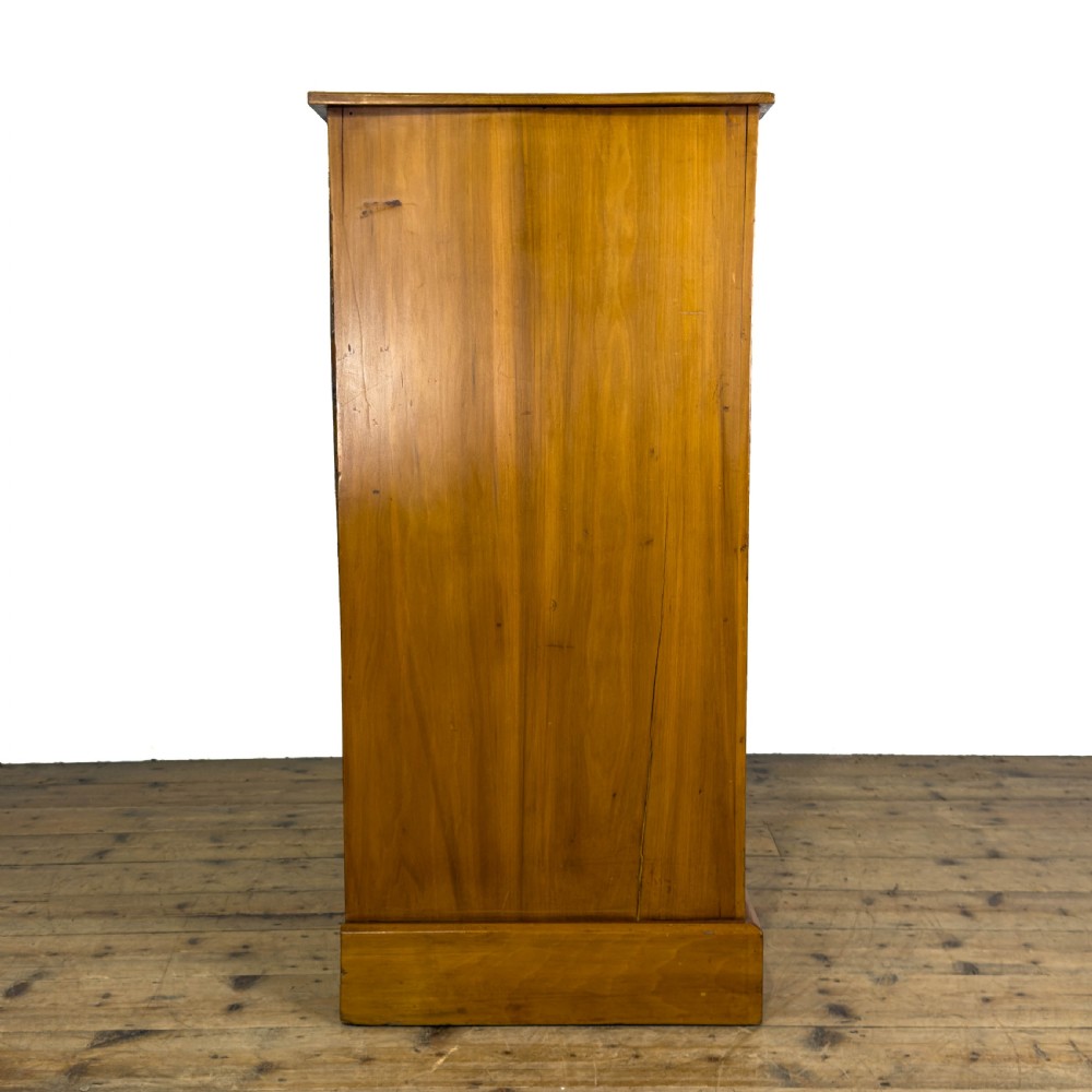 An Edwardian satinwood chest of drawers with two short drawers over three long drawers, featuring brass drop handles and a plinth base. View VI