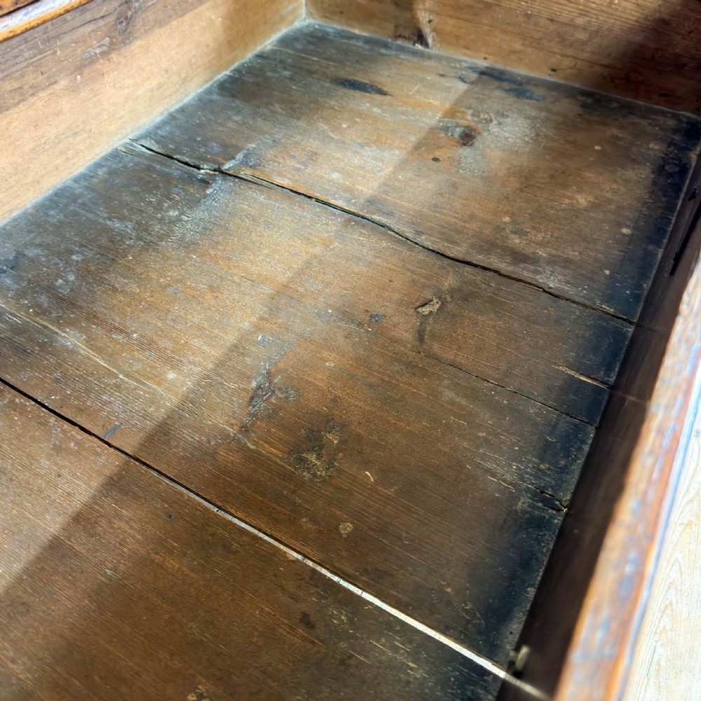 An antique 18th-century oak chest of drawers featuring a two short over three long drawer arrangement, brass handles, and turned bun feet. View XII
