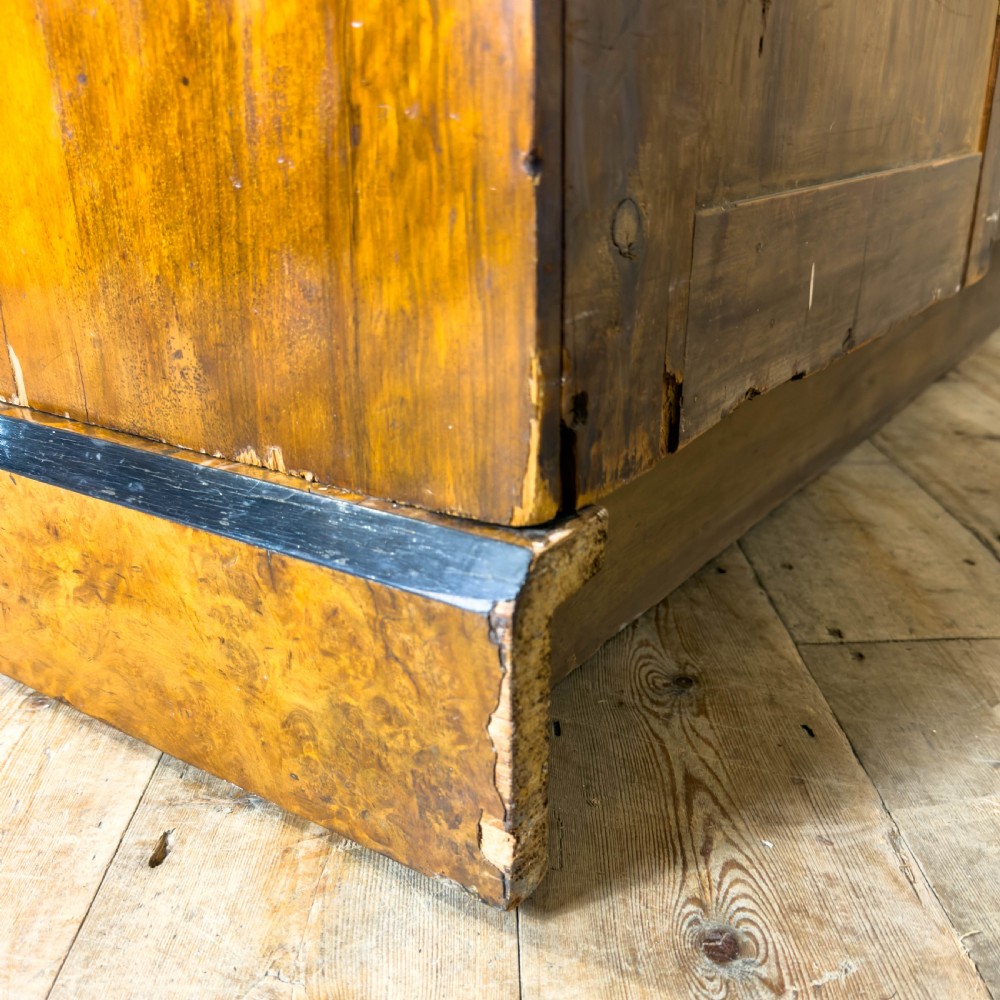 A Victorian burr walnut triple compactum wardrobe with an arched central mirrored door flanked by two panelled timber doors and topped with a castellated cornice. View VIII