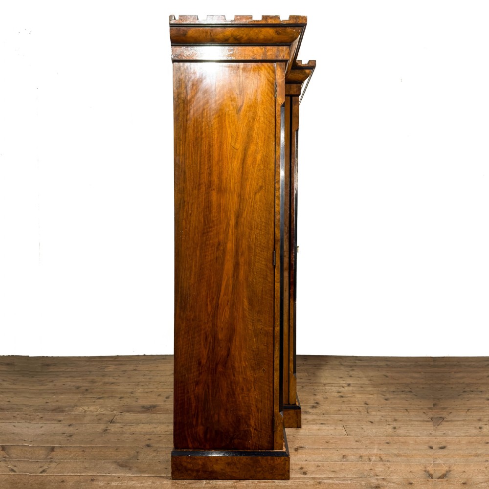 A Victorian burr walnut triple compactum wardrobe with an arched central mirrored door flanked by two panelled timber doors and topped with a castellated cornice. View XIV