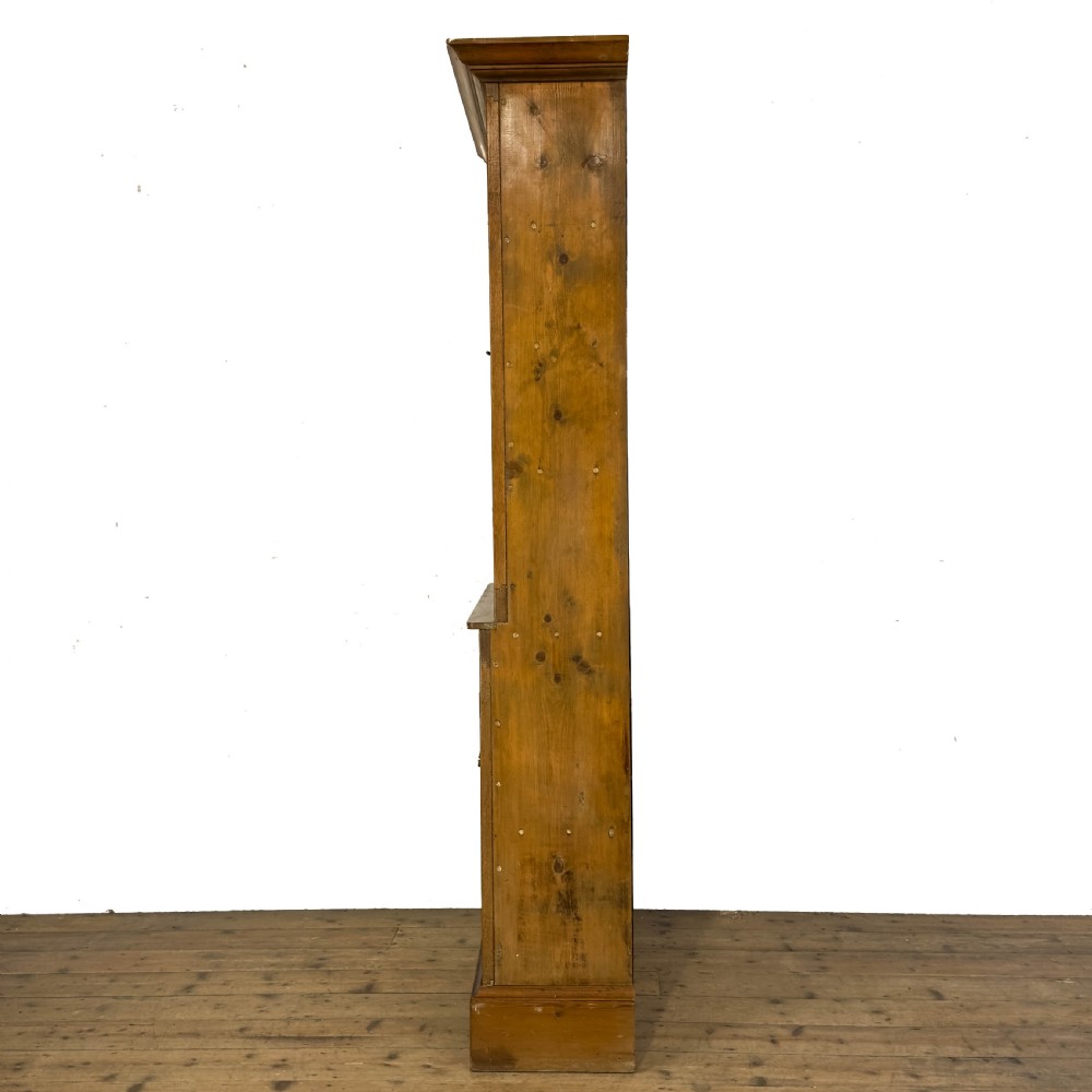 An early 20th-century golden oak cupboard featuring upper glazed double doors over lower solid panelled doors with brass hardware. View VI