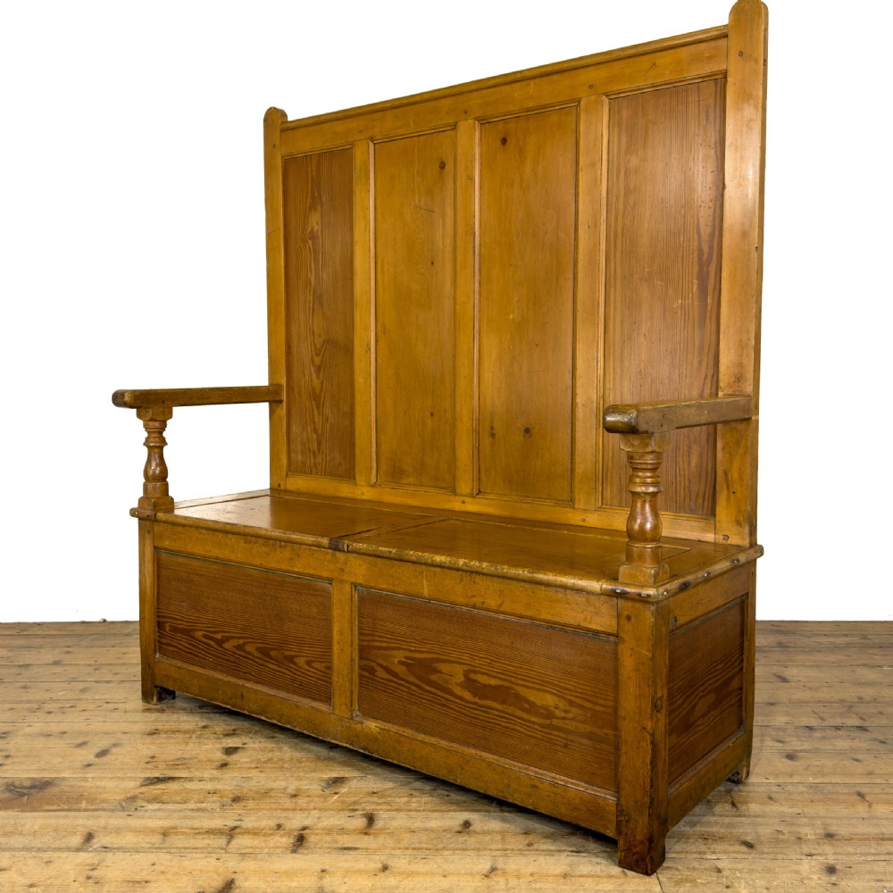 A high-backed antique pine settle bench with a four-panel backrest, turned arm supports, and a hinged seat box. View II
