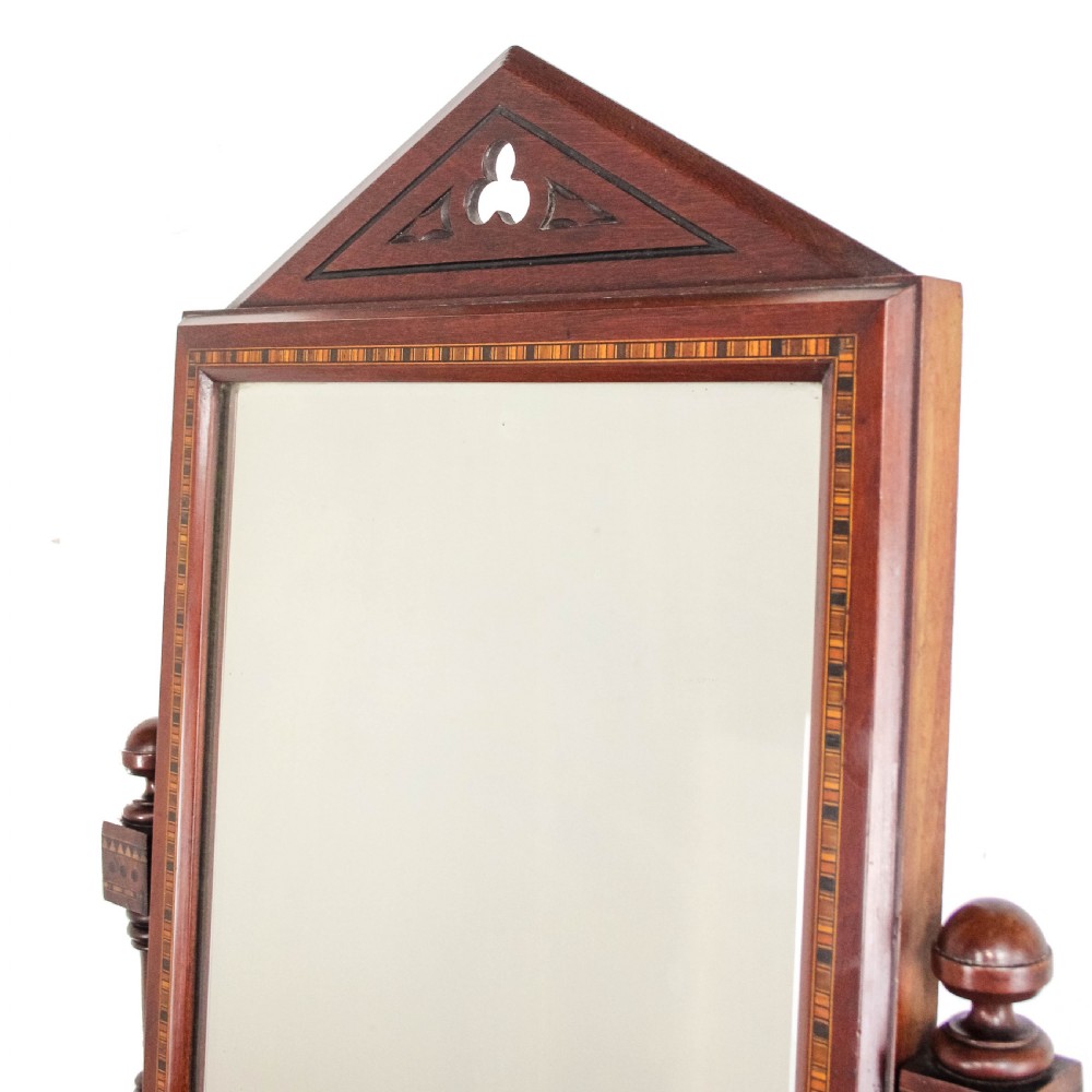A Victorian Gothic mahogany swing mirror featuring a pointed arch pediment with a trefoil cutout, turned side columns, and geometric inlay borders. View II
