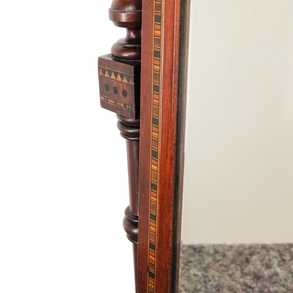 A Victorian Gothic mahogany swing mirror featuring a pointed arch pediment with a trefoil cutout, turned side columns, and geometric inlay borders. View VI
