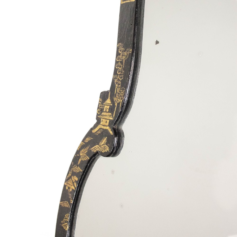An antique ebonised table mirror featuring a scalloped frame decorated with gold hand-painted chinoiserie motifs. View V
