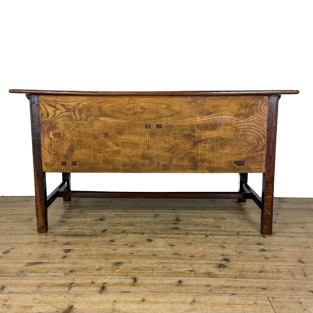 An antique oak serving table featuring brass drop handles, multiple drawer compartments, a scalloped apron, and straight legs connected by stretchers. View IV