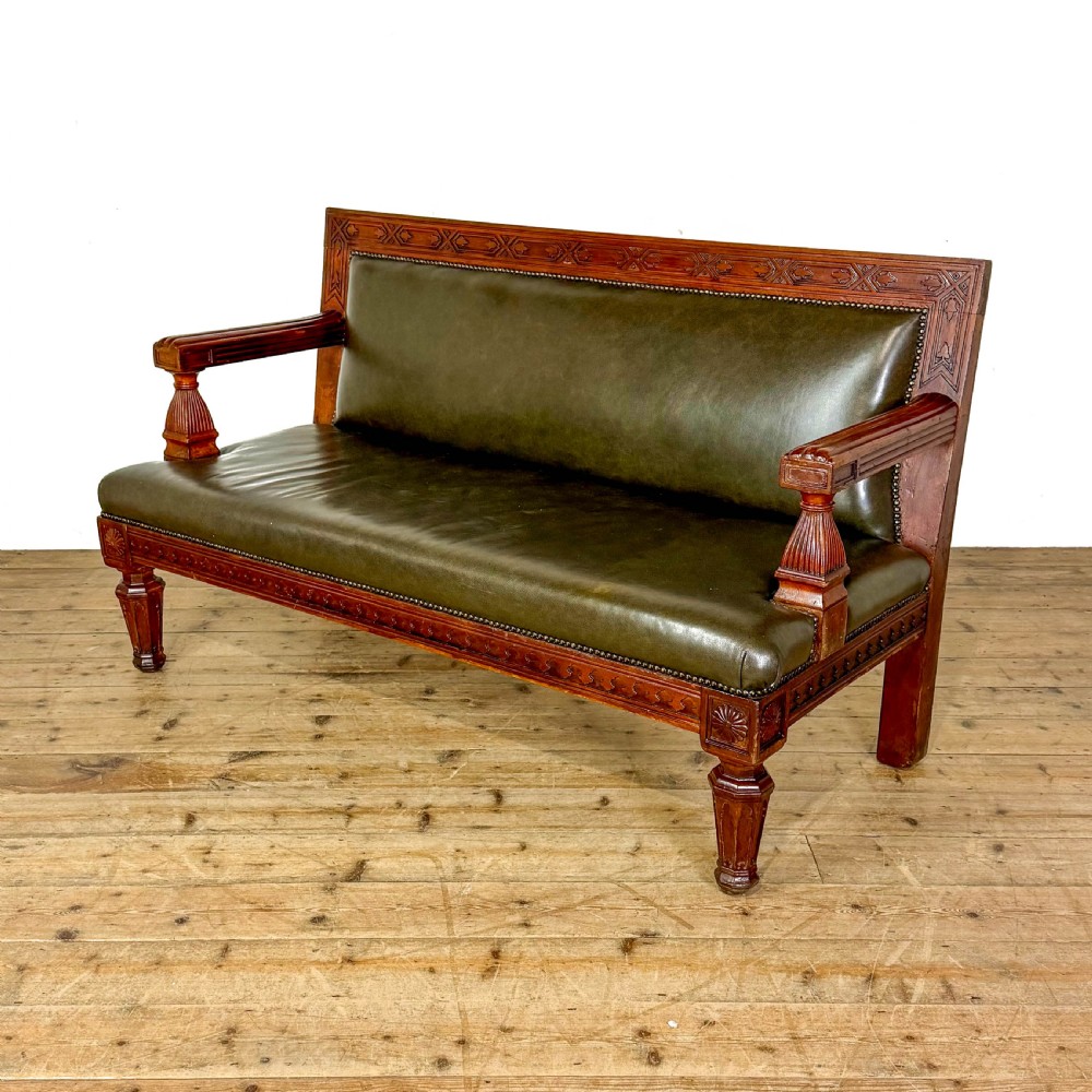 Late nineteenth-century carved oak hall settle featuring olive green leather upholstery with brass stud trim and turned legs. View II