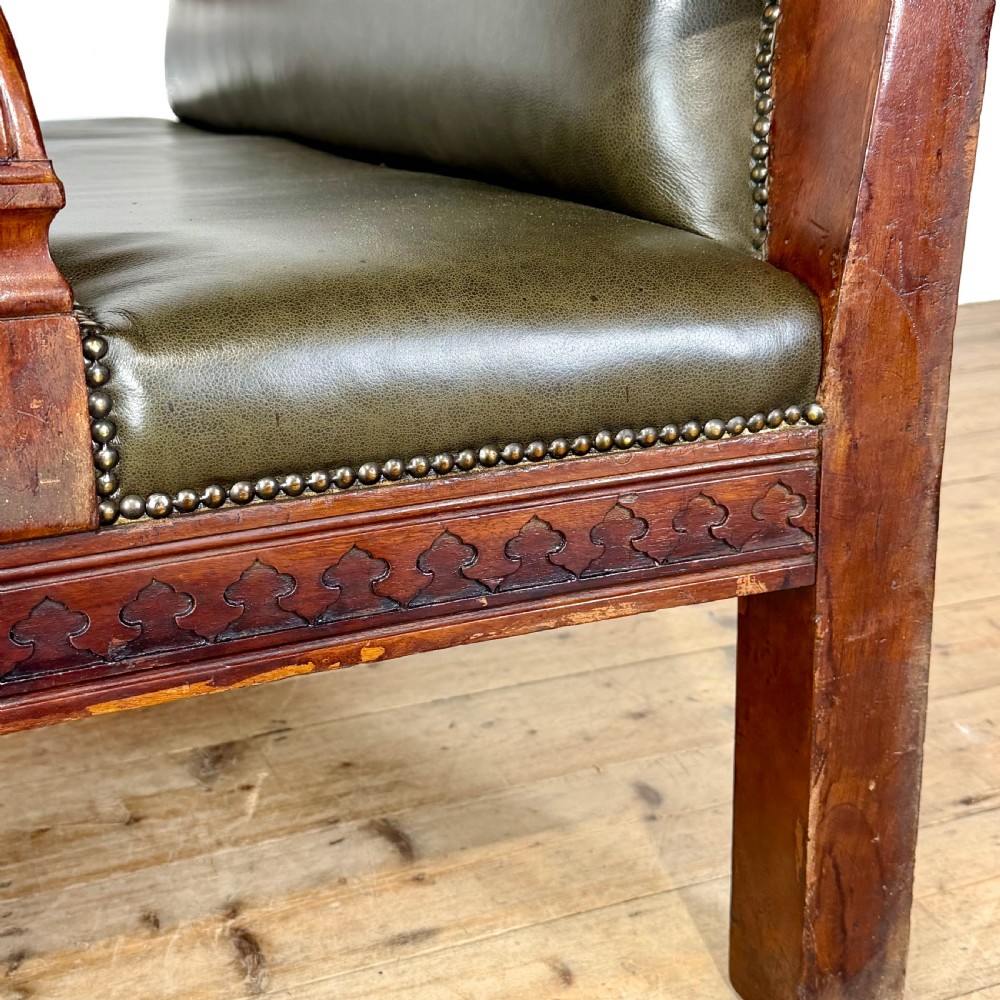 Late nineteenth-century carved oak hall settle featuring olive green leather upholstery with brass stud trim and turned legs. View III