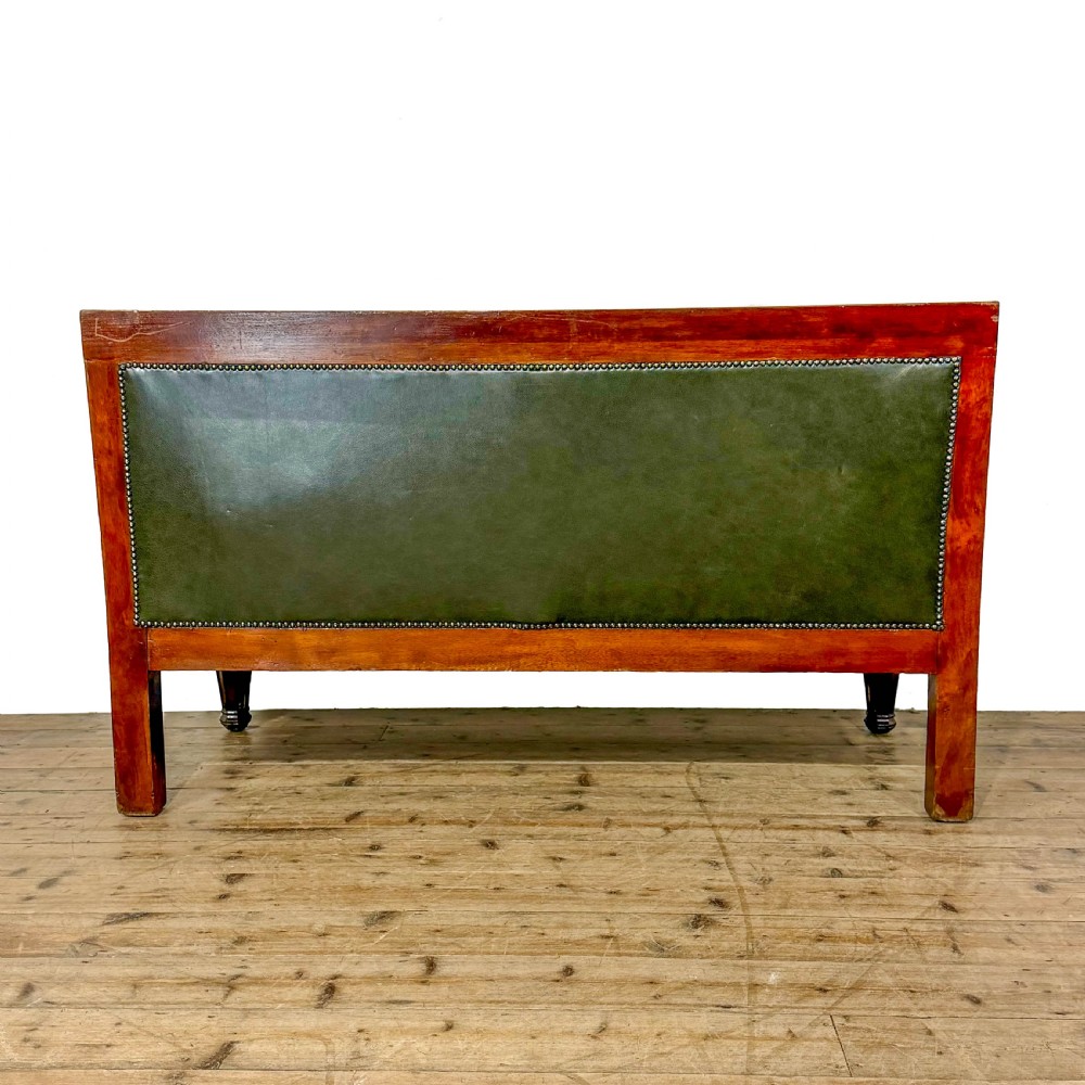 Late nineteenth-century carved oak hall settle featuring olive green leather upholstery with brass stud trim and turned legs. View IV