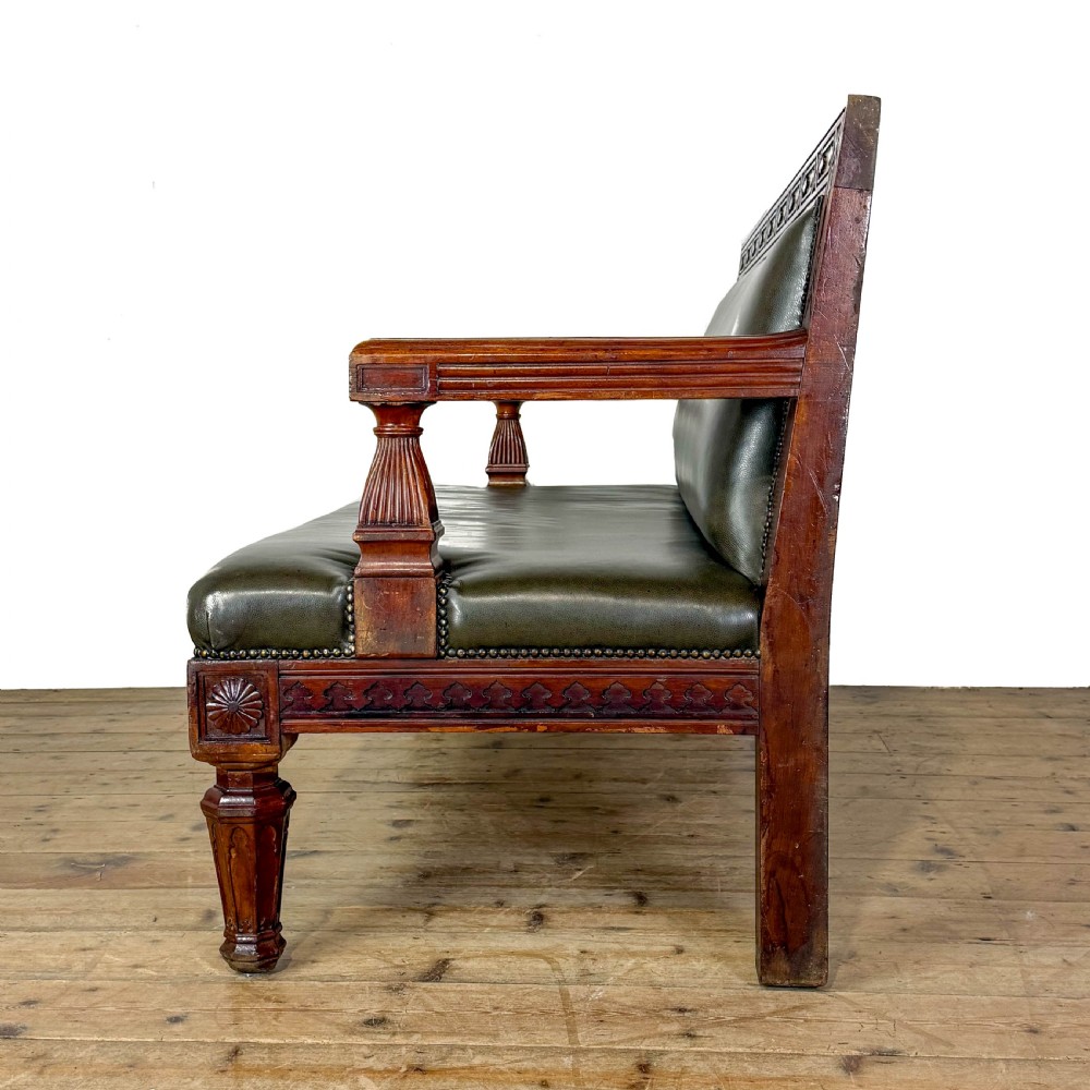 Late nineteenth-century carved oak hall settle featuring olive green leather upholstery with brass stud trim and turned legs. View VII