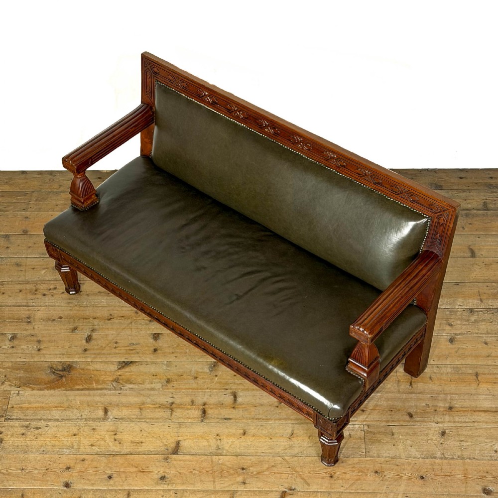 Late nineteenth-century carved oak hall settle featuring olive green leather upholstery with brass stud trim and turned legs. View VIII