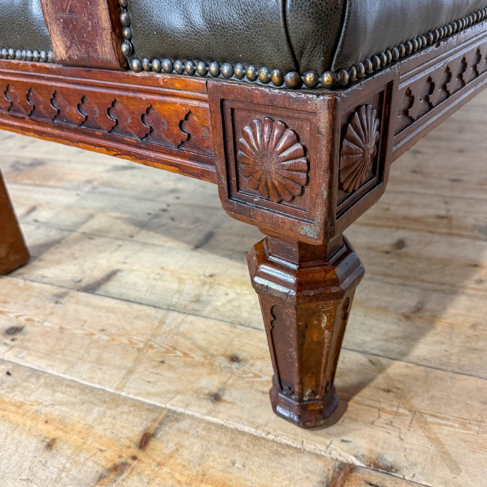 Late nineteenth-century carved oak hall settle featuring olive green leather upholstery with brass stud trim and turned legs. View X