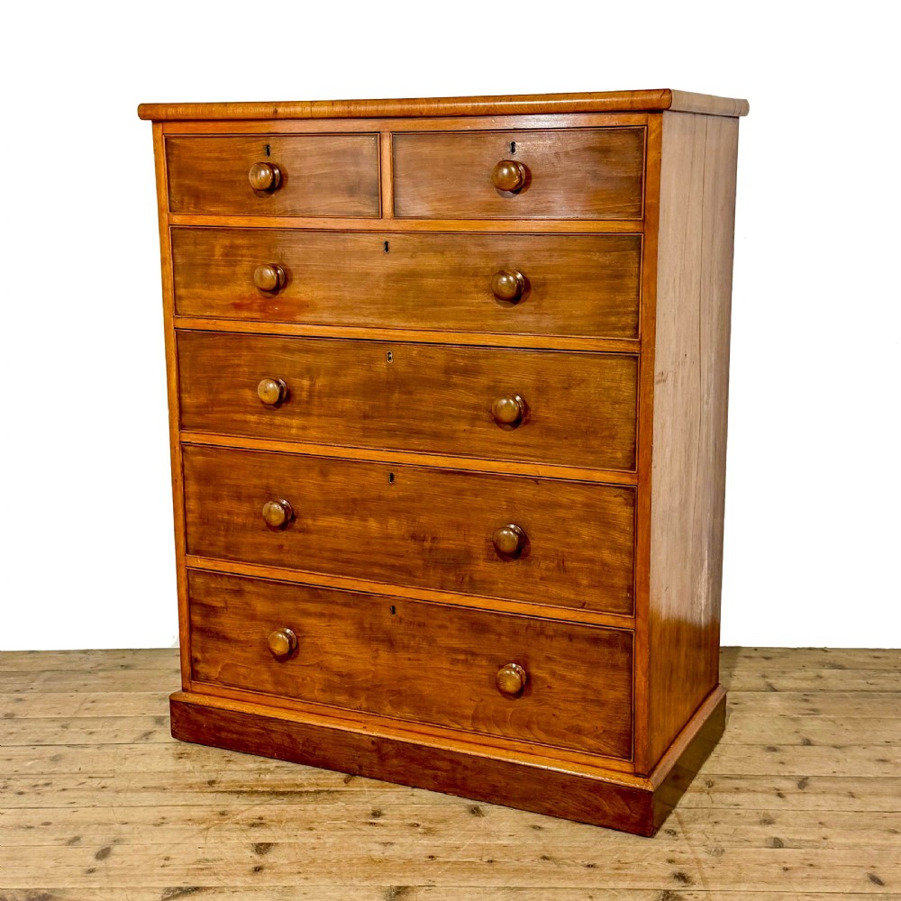 An antique Victorian mahogany tall chest of drawers featuring two short upper drawers above four long lower drawers with turned wooden knobs on a solid plinth base. View II