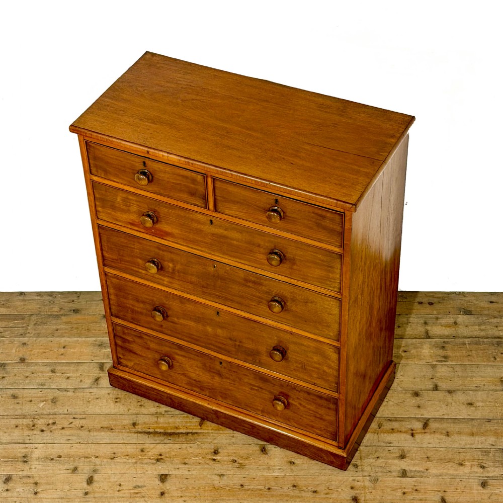An antique Victorian mahogany tall chest of drawers featuring two short upper drawers above four long lower drawers with turned wooden knobs on a solid plinth base. View III