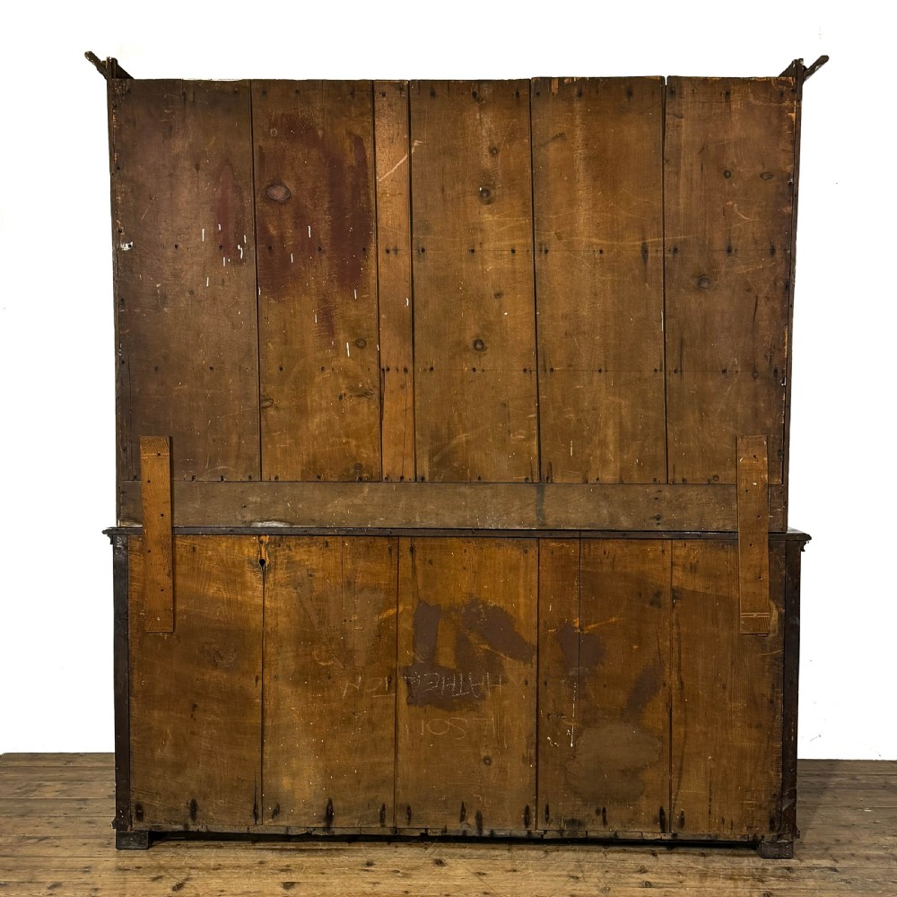An antique Georgian dark oak dresser featuring an upper shelving rack, small cupboard doors with diamond inlay, and a base containing multiple drawers and panelled cupboards with brass handles. View VII