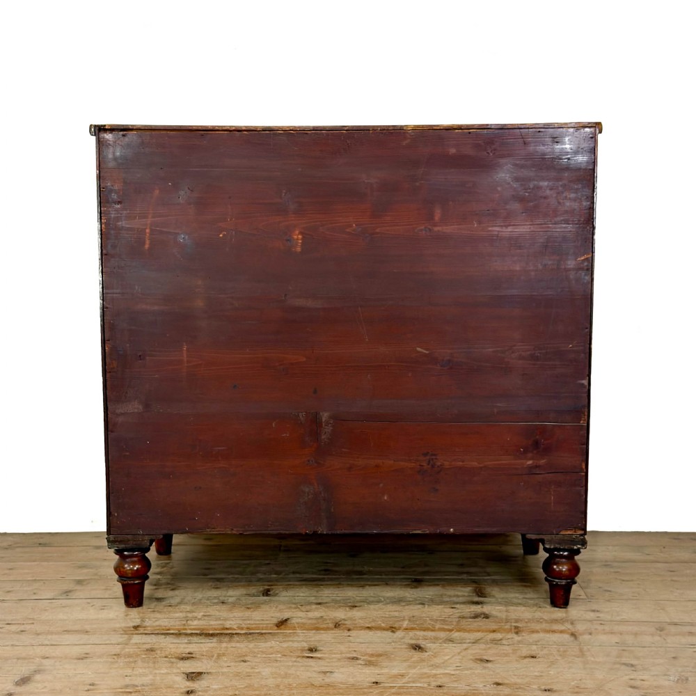 An antique mahogany bow front chest of drawers with two short drawers over three long graduated drawers, turned wooden handles, and turned feet. View VI