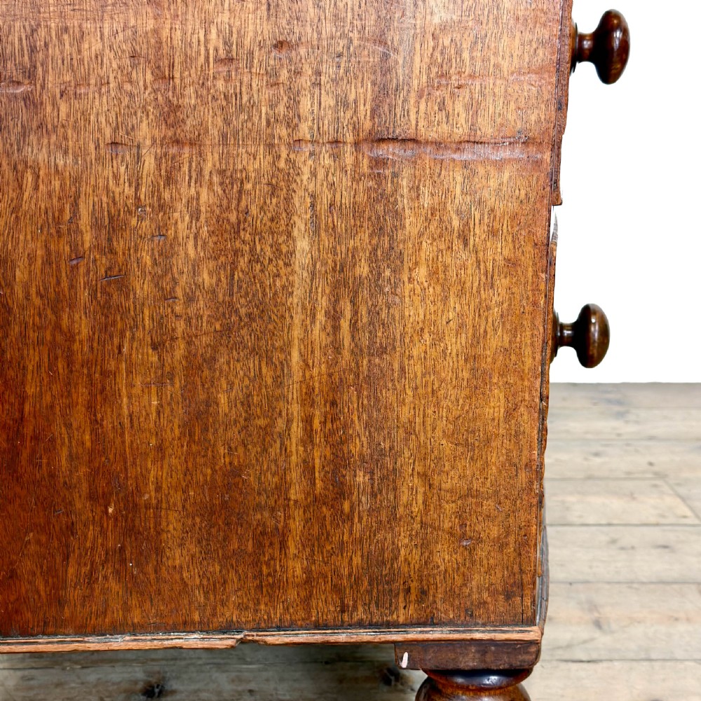 An antique mahogany bow front chest of drawers with two short drawers over three long graduated drawers, turned wooden handles, and turned feet. View VIII